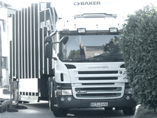 A Baker-Container leaves the premises. A Baker-Container leaves the premises.