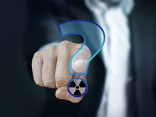 A finger points to a question mark with a radioactivity symbol A finger points to a question mark with a radioactivity symbol