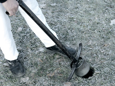 A staff takes a soil sample A staff takes a soil sample