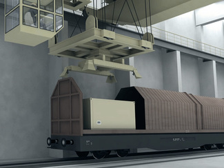 In the reloading hall an overhead crane picks up the waste packages from the freight car