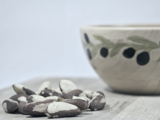 Brazil nuts in front of a bowl Brazil nuts in front of a bowl