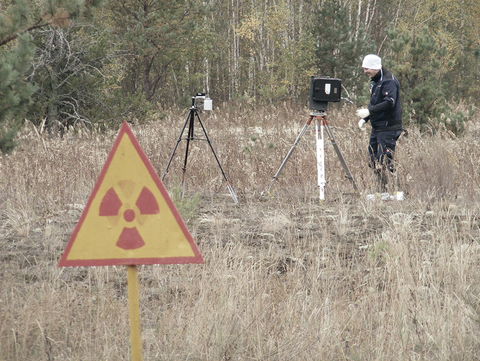 Measuring the radioactivity in the exclusion zone around the damaged Chernobyl nuclear power plant with two different types of gamma spectrometers - in the foreground a sign warns against enhanced levels of radioactivity Measuring the radioactivity in the exclusion zone around the damaged Chernobyl nuclear power plant with two different types of gamma spectrometers - in the foreground a sign warns against enhanced levels of radioactivity